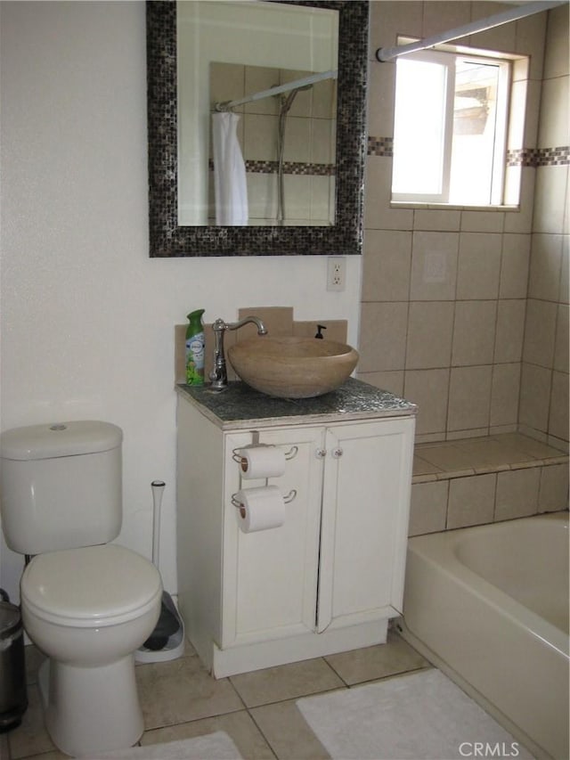 bathroom with a shower with shower curtain, tile patterned flooring, toilet, vanity, and a tub to relax in