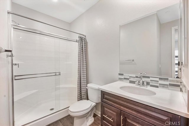 34428 Burnt Pine Rd, Murrieta, CA 92563 - full bathroom featuring a stall shower, wood finished floors, toilet, vanity, and baseboards