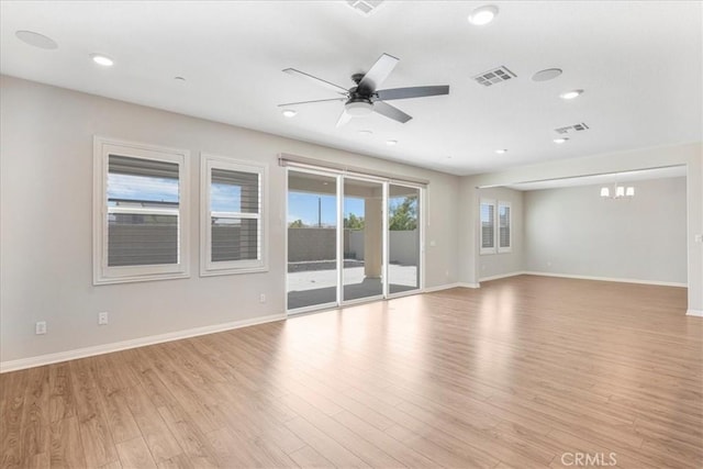 34428 Burnt Pine Rd, Murrieta, CA 92563 - unfurnished room featuring baseboards, ceiling fan, light wood-style floors, recessed lighting, and a chandelier