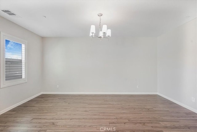 34428 Burnt Pine Rd, Murrieta, CA 92563 - empty room with a chandelier, wood finished floors, and baseboards