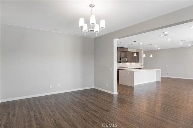 34428 Burnt Pine Rd, Murrieta, CA 92563 - unfurnished living room with a chandelier, dark wood-type flooring, baseboards, and recessed lighting