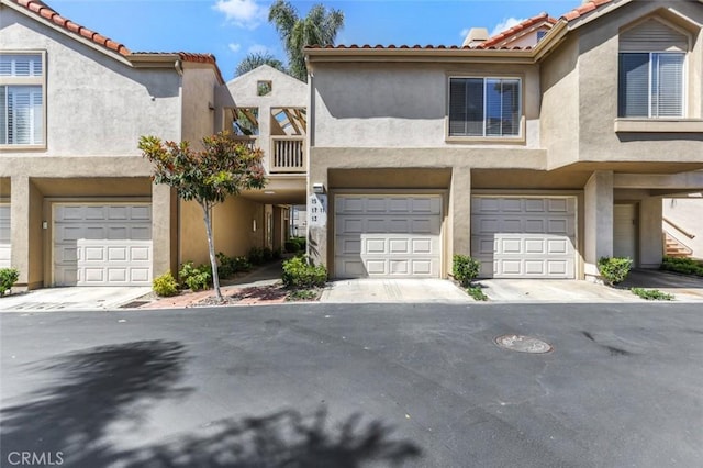 11 Avalon Unit 23, Laguna Niguel, CA 92677 - townhome / multi-family property featuring a garage, stucco siding, a tile roof, and driveway