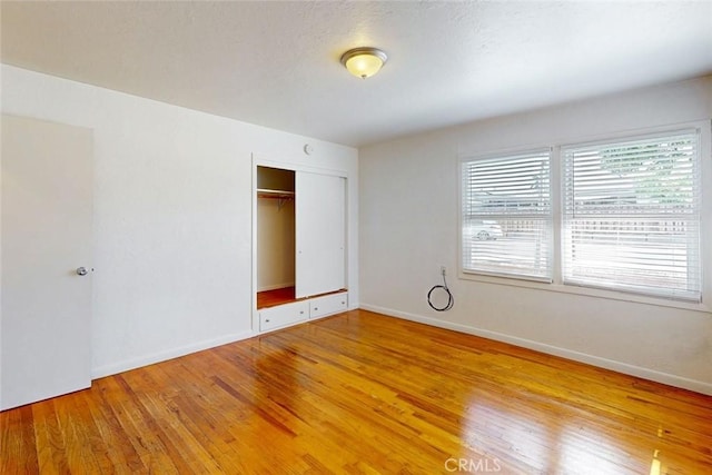 2234 Perkins Ave, Oroville, CA 95966 - unfurnished bedroom featuring light wood-style flooring, a closet, and baseboards