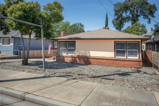 2234 Perkins Ave, Oroville, CA 95966 - view of front of house featuring a chimney, brick siding, and fence