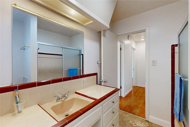 2234 Perkins Ave, Oroville, CA 95966 - full bath featuring vanity, a shower with shower door, decorative backsplash, and baseboards