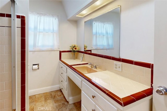2234 Perkins Ave, Oroville, CA 95966 - bathroom featuring plenty of natural light, backsplash, vanity, and baseboards