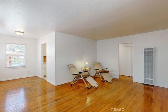 2234 Perkins Ave, Oroville, CA 95966 - empty room with a heating unit, light wood-style flooring, baseboards, and a textured ceiling