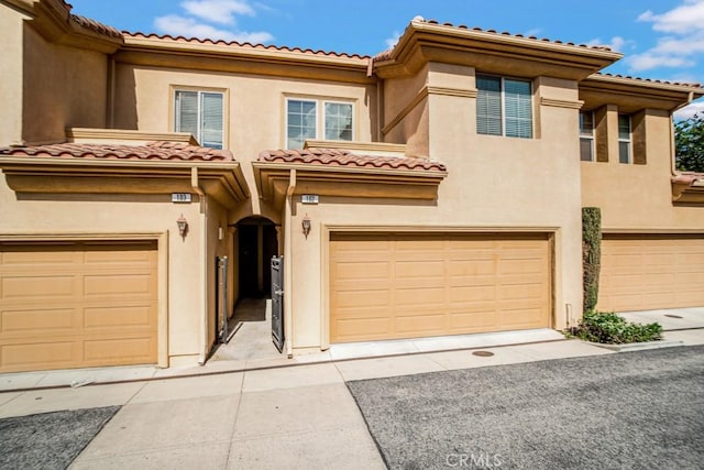 1440 Patricia Ave Unit 102, Simi Valley, CA 93065 - view of front of home featuring an attached garage, driveway, and stucco siding