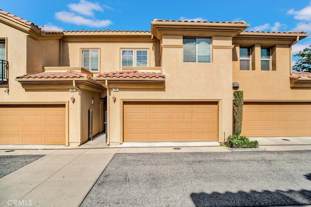 1440 Patricia Ave Unit 102, Simi Valley, CA 93065 - view of front of home featuring an attached garage, stucco siding, and a tile roof