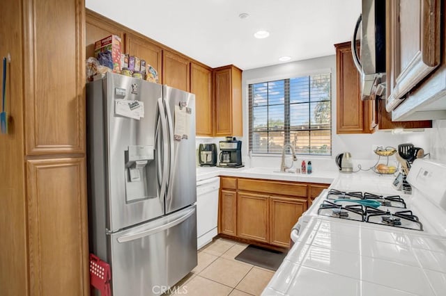 1440 Patricia Ave Unit 102, Simi Valley, CA 93065 - kitchen with appliances with stainless steel finishes, tile counters, brown cabinets, light tile patterned floors, and recessed lighting