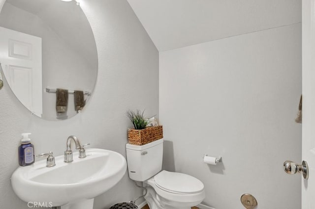 1440 Patricia Ave Unit 102, Simi Valley, CA 93065 - half bath with a sink, lofted ceiling, toilet, and baseboards