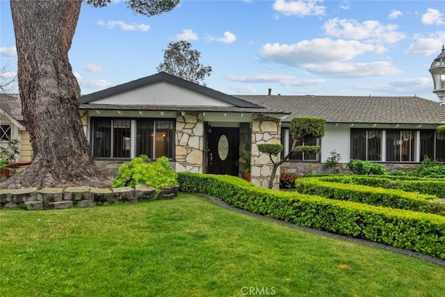 1425 Belleau Rd, Glendale, CA 91206 - view of front of house featuring stone siding, a front lawn, and a shingled roof