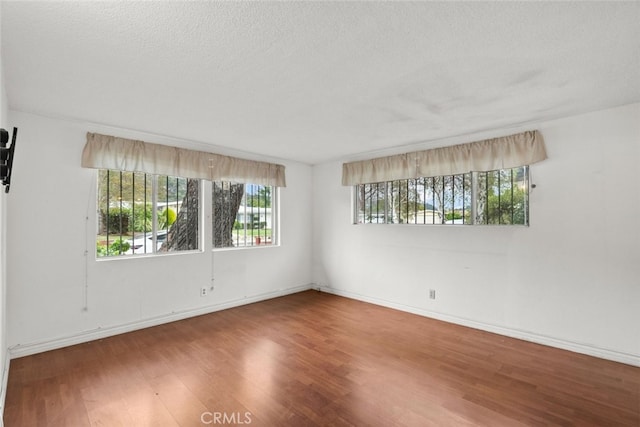 1425 Belleau Rd, Glendale, CA 91206 - empty room featuring wood finished floors, a textured ceiling, and baseboards