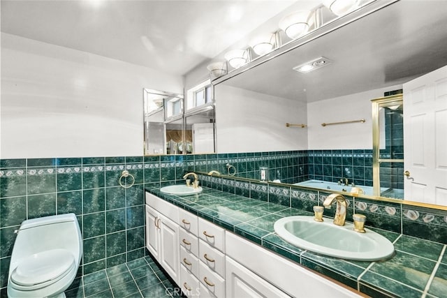 1425 Belleau Rd, Glendale, CA 91206 - bathroom featuring tile patterned floors, tile walls, a garden tub, toilet, and double vanity