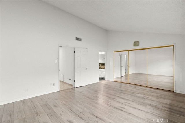 1425 Belleau Rd, Glendale, CA 91206 - unfurnished bedroom featuring wood finished floors, high vaulted ceiling, baseboards, and ensuite bath