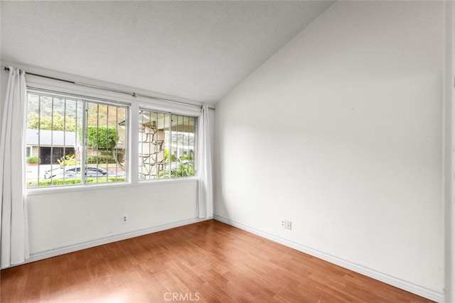 1425 Belleau Rd, Glendale, CA 91206 - empty room with vaulted ceiling, light wood-style flooring, healthy amount of natural light, and baseboards