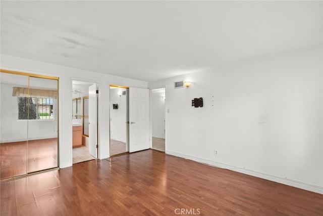 1425 Belleau Rd, Glendale, CA 91206 - unfurnished bedroom with wood finished floors, baseboards, and connected bathroom