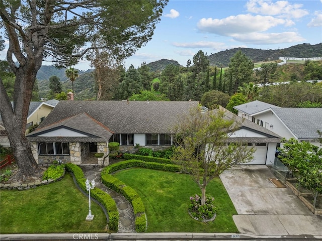1425 Belleau Rd, Glendale, CA 91206 - ranch-style house featuring stone siding, a mountain view, a garage, and driveway