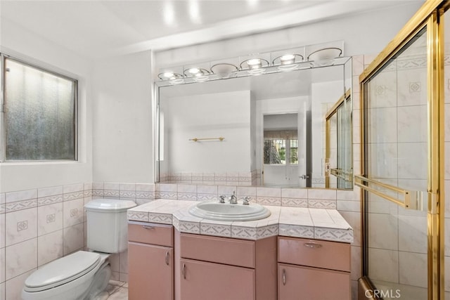 1425 Belleau Rd, Glendale, CA 91206 - bathroom featuring tile walls, tiled shower, toilet, vanity, and wainscoting