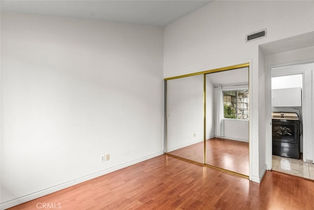 1425 Belleau Rd, Glendale, CA 91206 - unfurnished bedroom with washer / dryer, wood finished floors, a closet, and baseboards
