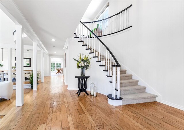 19365 Woodlands Dr, Huntington Beach, CA 92648 - staircase featuring hardwood / wood-style floors and baseboards