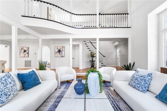 19365 Woodlands Dr, Huntington Beach, CA 92648 - living area featuring a high ceiling, stairs, wood finished floors, and arched walkways