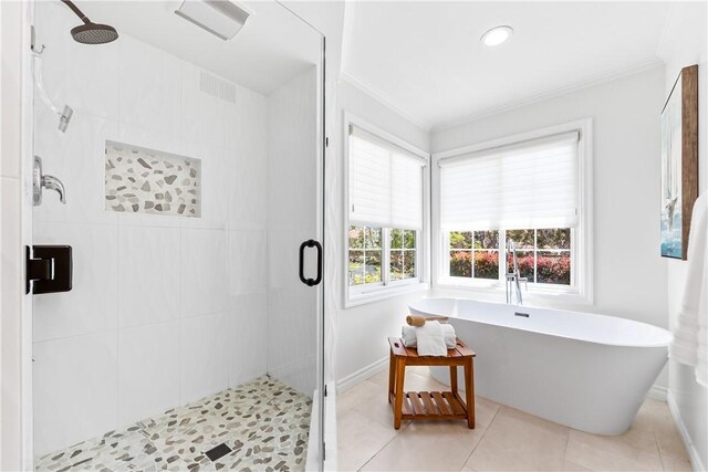 19365 Woodlands Dr, Huntington Beach, CA 92648 - bathroom featuring crown molding, baseboards, a shower stall, a soaking tub, and tile patterned floors