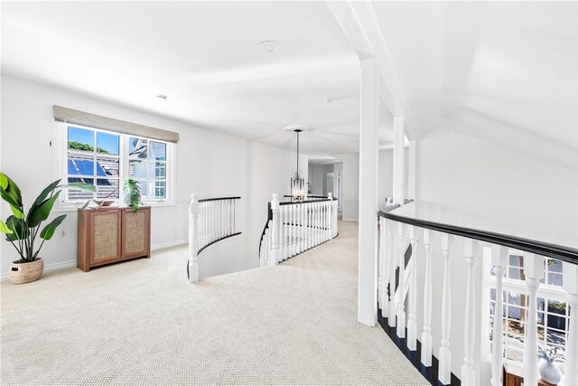 19365 Woodlands Dr, Huntington Beach, CA 92648 - hall with an upstairs landing, carpet flooring, baseboards, and a chandelier