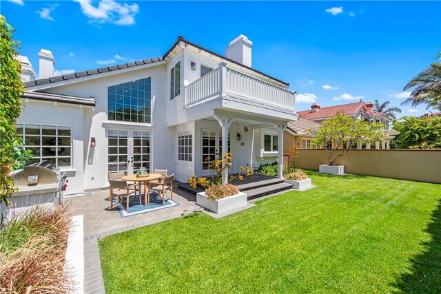 19365 Woodlands Dr, Huntington Beach, CA 92648 - rear view of property with a balcony, a chimney, stucco siding, a patio area, and french doors