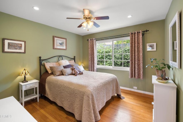 bedroom featuring light wood-type flooring, baseboards, recessed lighting, and a ceiling fan