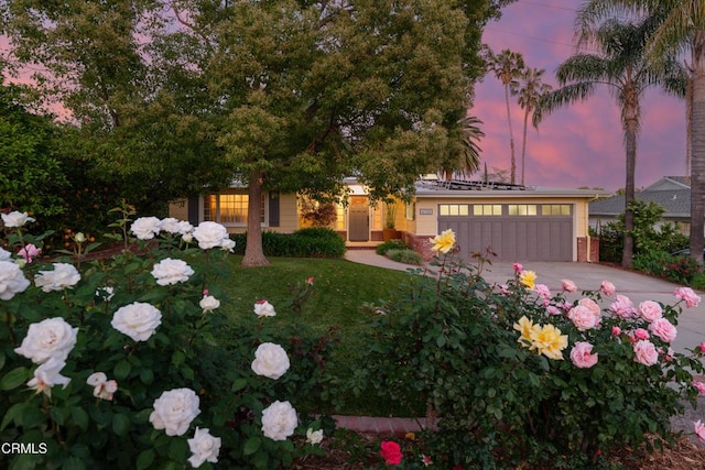 view of front of home with an attached garage and concrete driveway