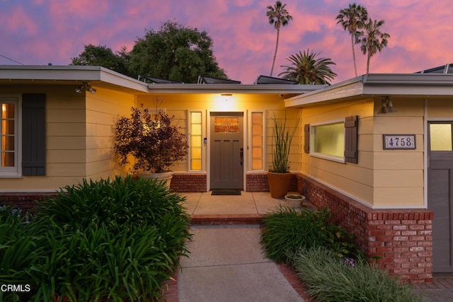 property entrance with brick siding