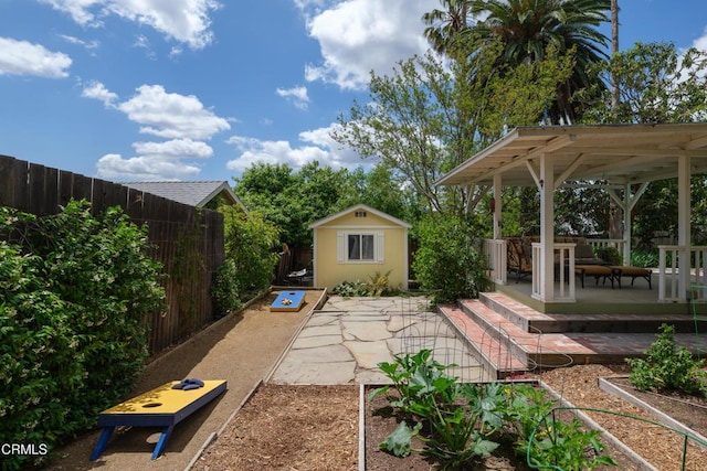 fenced backyard featuring an outbuilding and a patio