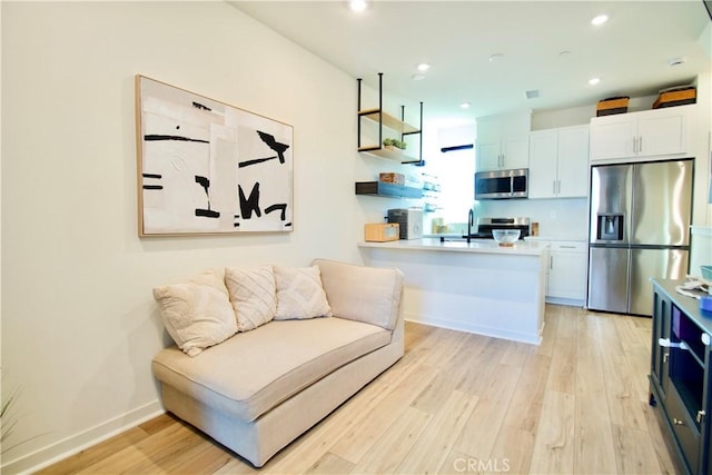 1567 Lima Way Unit 4, Placentia, CA 92870 - living room featuring light wood-style floors, recessed lighting, and baseboards