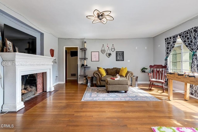 1065 Nithsdale Rd, Pasadena, CA 91105 - living area featuring wood finished floors, baseboards, and a fireplace with flush hearth