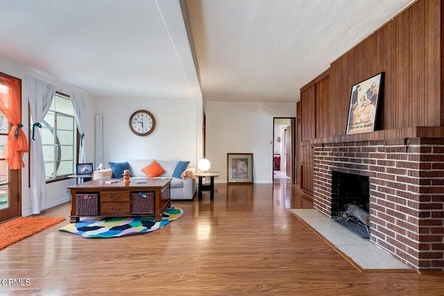 1065 Nithsdale Rd, Pasadena, CA 91105 - living area with a fireplace, wood finished floors, baseboards, and wooden walls