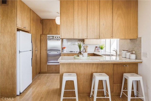 1737 Via Boronada, Palos Verdes Estates, CA 90274 - kitchen featuring freestanding refrigerator, a peninsula, light wood finished floors, multiple ovens, and tasteful backsplash
