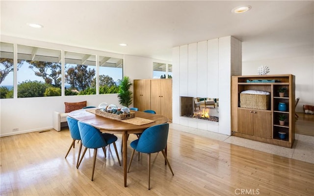 1737 Via Boronada, Palos Verdes Estates, CA 90274 - dining area with wood finished floors, a multi sided fireplace, and recessed lighting