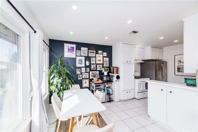 1850 W Greenleaf Ave Unit G, Anaheim, CA 92801 - kitchen with gas range gas stove, freestanding refrigerator, white cabinetry, under cabinet range hood, and recessed lighting