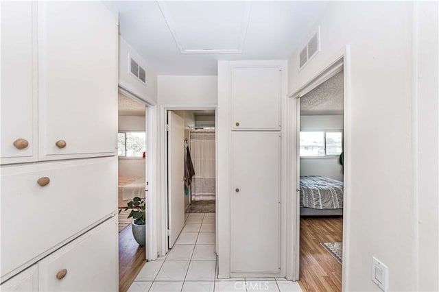 1850 W Greenleaf Ave Unit G, Anaheim, CA 92801 - hallway featuring healthy amount of natural light, attic access, and light tile patterned floors