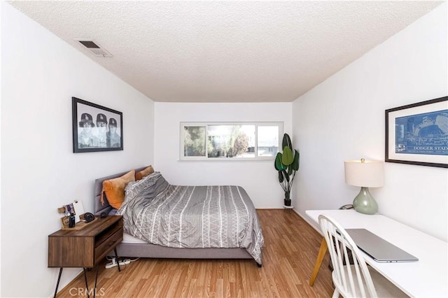 1850 W Greenleaf Ave Unit G, Anaheim, CA 92801 - bedroom featuring a textured ceiling and light wood-style flooring