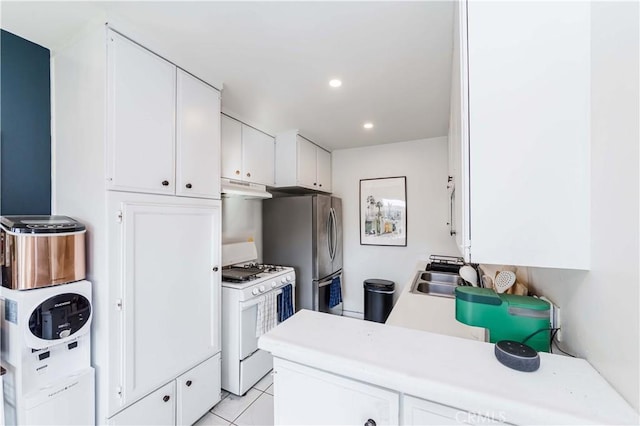 1850 W Greenleaf Ave Unit G, Anaheim, CA 92801 - kitchen featuring white gas range, under cabinet range hood, a sink, freestanding refrigerator, and white cabinetry