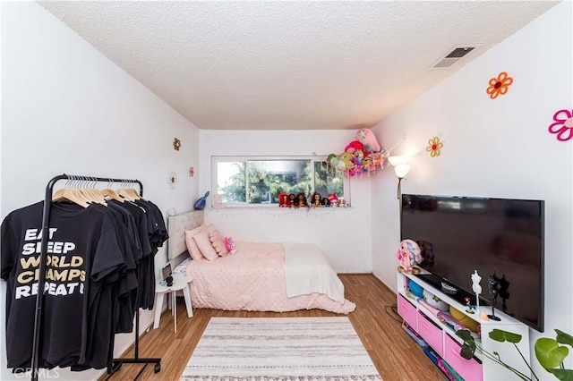 1850 W Greenleaf Ave Unit G, Anaheim, CA 92801 - bedroom with a textured ceiling and wood finished floors