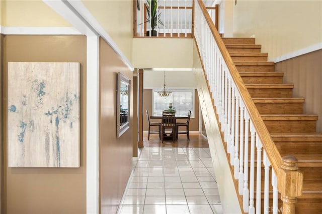 5642 Burlingame Ave, Buena Park, CA 90621 - stairs with a high ceiling, a chandelier, tile patterned floors, and baseboards