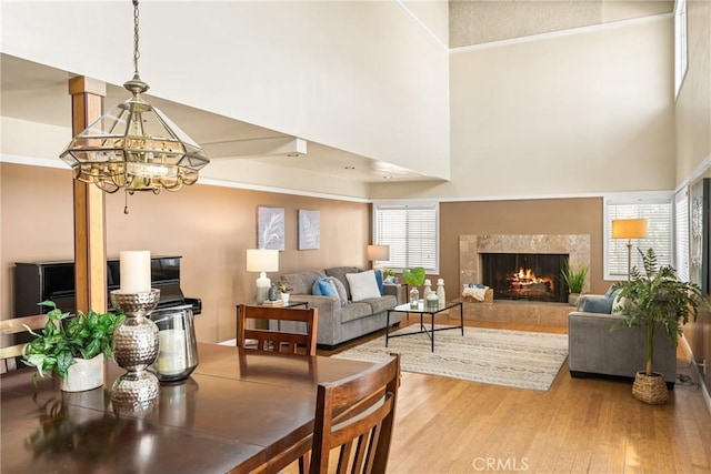 5642 Burlingame Ave, Buena Park, CA 90621 - living area with wood finished floors, a chandelier, a premium fireplace, and a towering ceiling