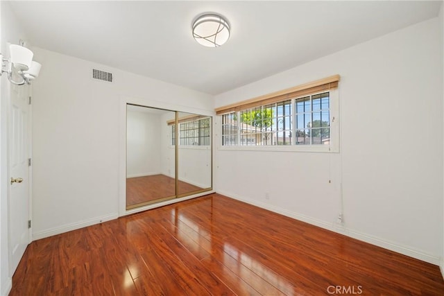 979 Ridgecrest St, Monterey Park, CA 91754 - unfurnished bedroom featuring wood finished floors, baseboards, and a closet
