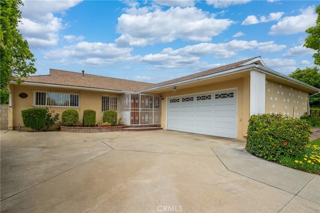 979 Ridgecrest St, Monterey Park, CA 91754 - ranch-style house with concrete driveway, a garage, and stucco siding