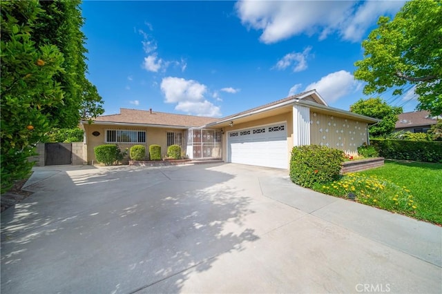 979 Ridgecrest St, Monterey Park, CA 91754 - view of front of property featuring driveway, a garage, and stucco siding
