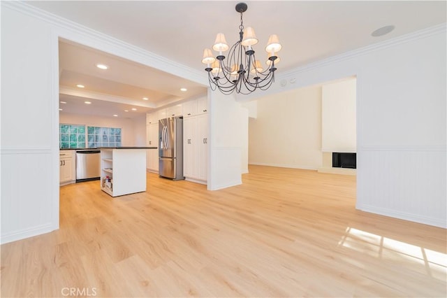 29355 Shell Cv, Laguna Niguel, CA 92677 - kitchen featuring stainless steel appliances, open floor plan, light wood-type flooring, dark countertops, and a chandelier