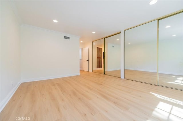 29355 Shell Cv, Laguna Niguel, CA 92677 - unfurnished bedroom featuring two closets, ornamental molding, light wood-style floors, baseboards, and recessed lighting